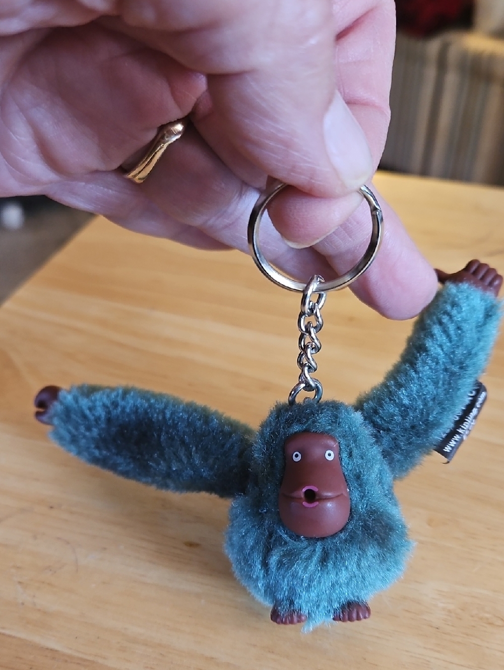 Kipling brand teal green gorilla monkey bag charm.